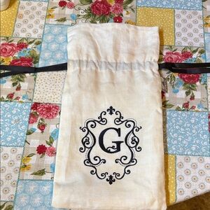 Elegant White Drawstring Pouch with Black Monogram